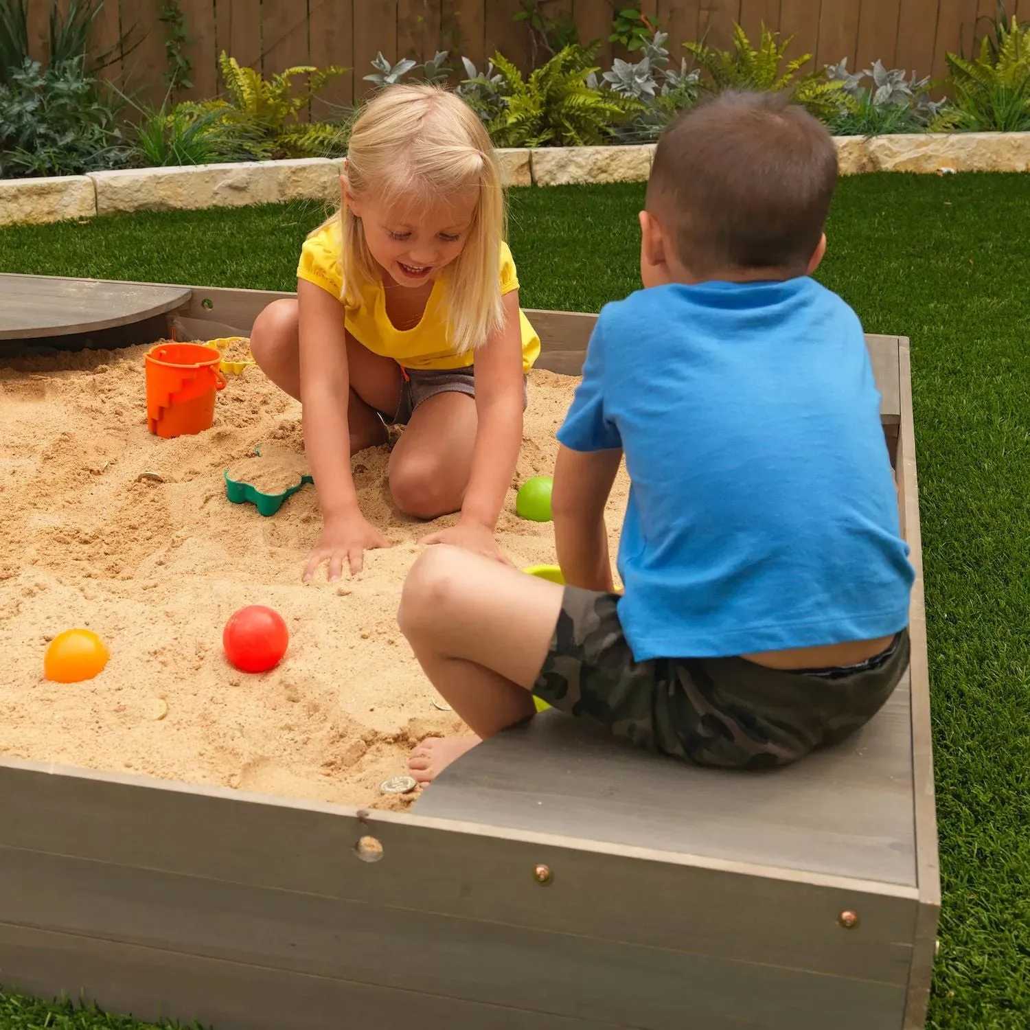 KidKraft Sandbox in the backyard KidKraft